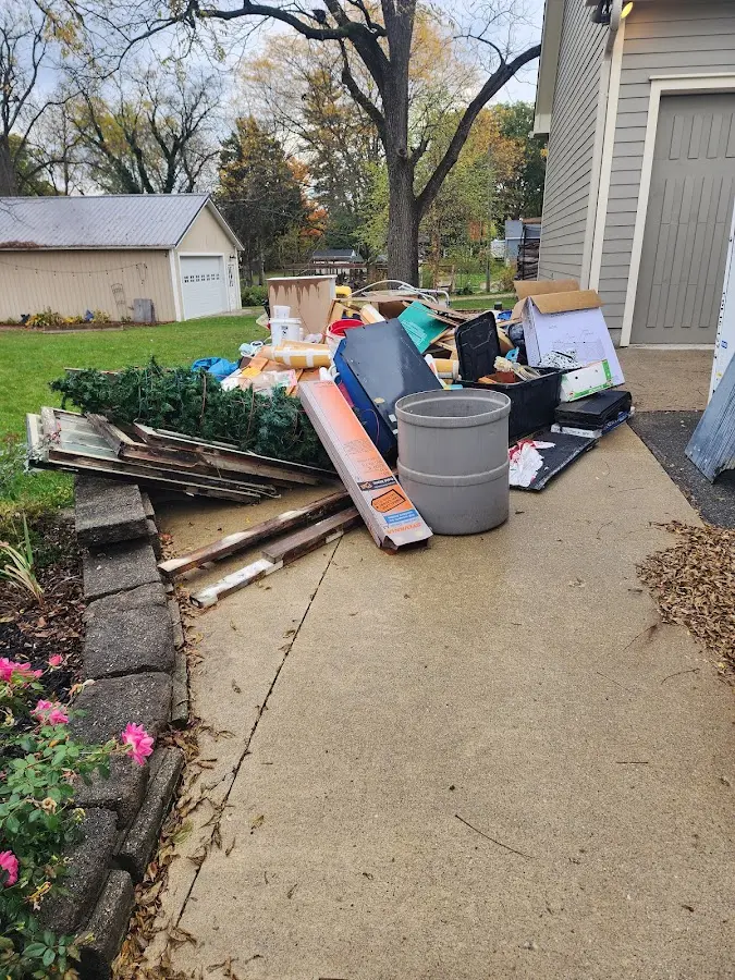 Dumpster being loaded with debris for Estate Cleanout Dumpster Rental in Douglass Hills